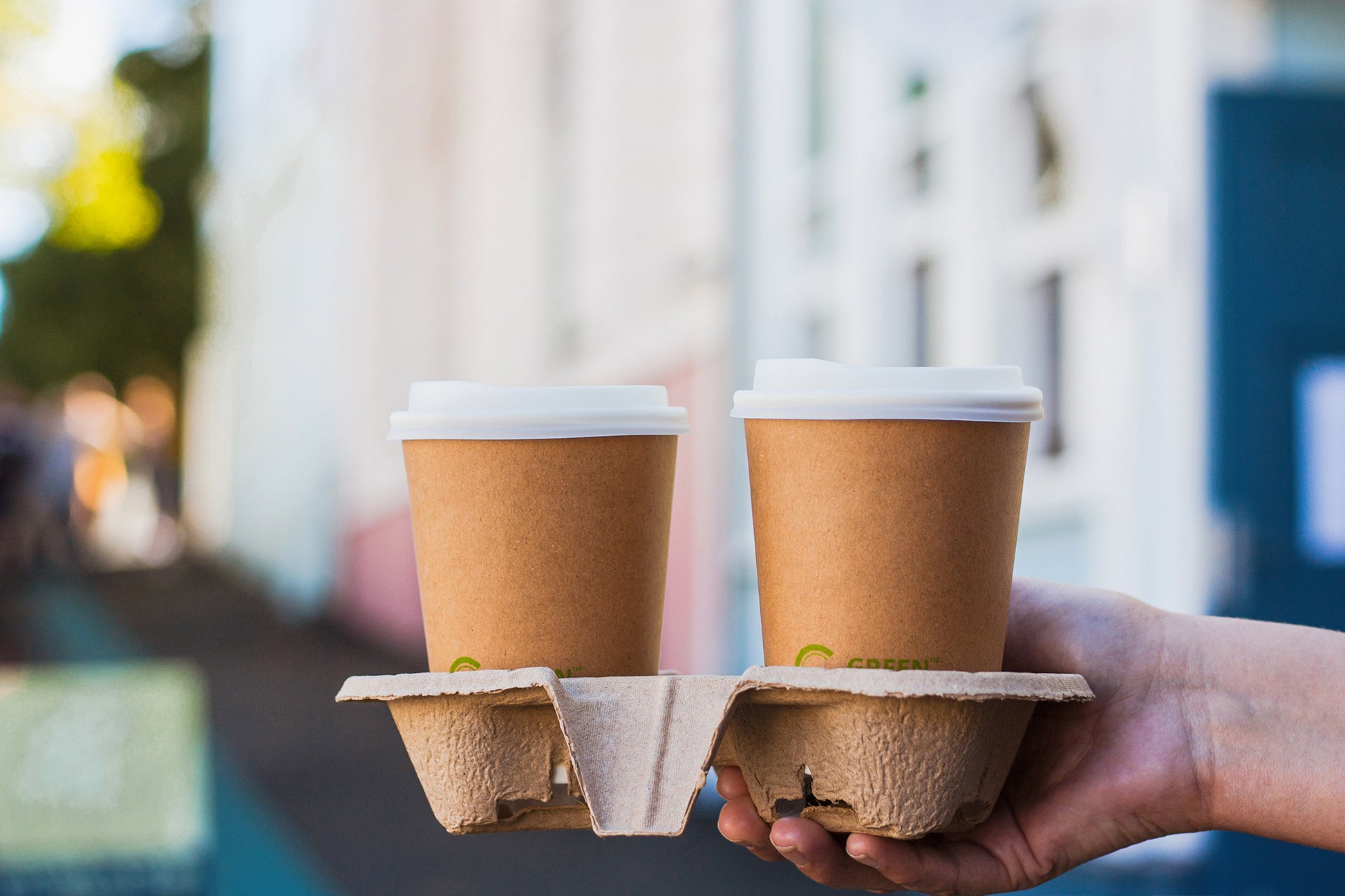 Two coffees being carried in a 2 compartment Pulp Cardboard Cup Holder